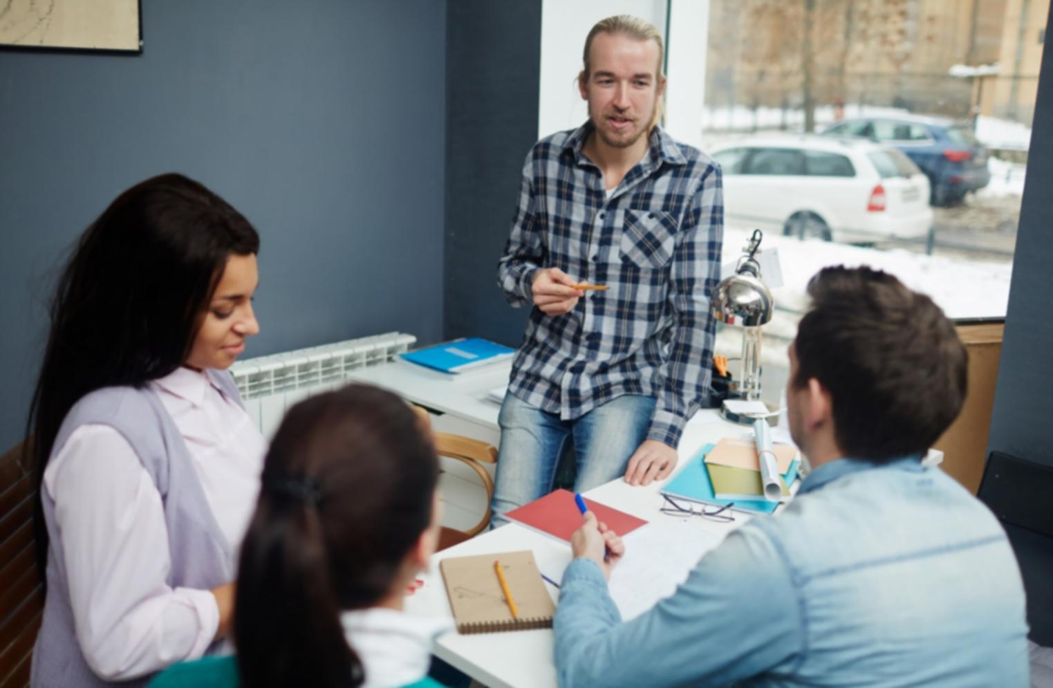 Persona organizando documentos financieros en una mesa de trabajo